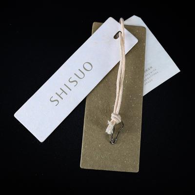 China Luxury Customized Clothes Name Brand Embossed Logos Jewelry Paper Printed Swing Hang Tags with Cotton String for Clothing